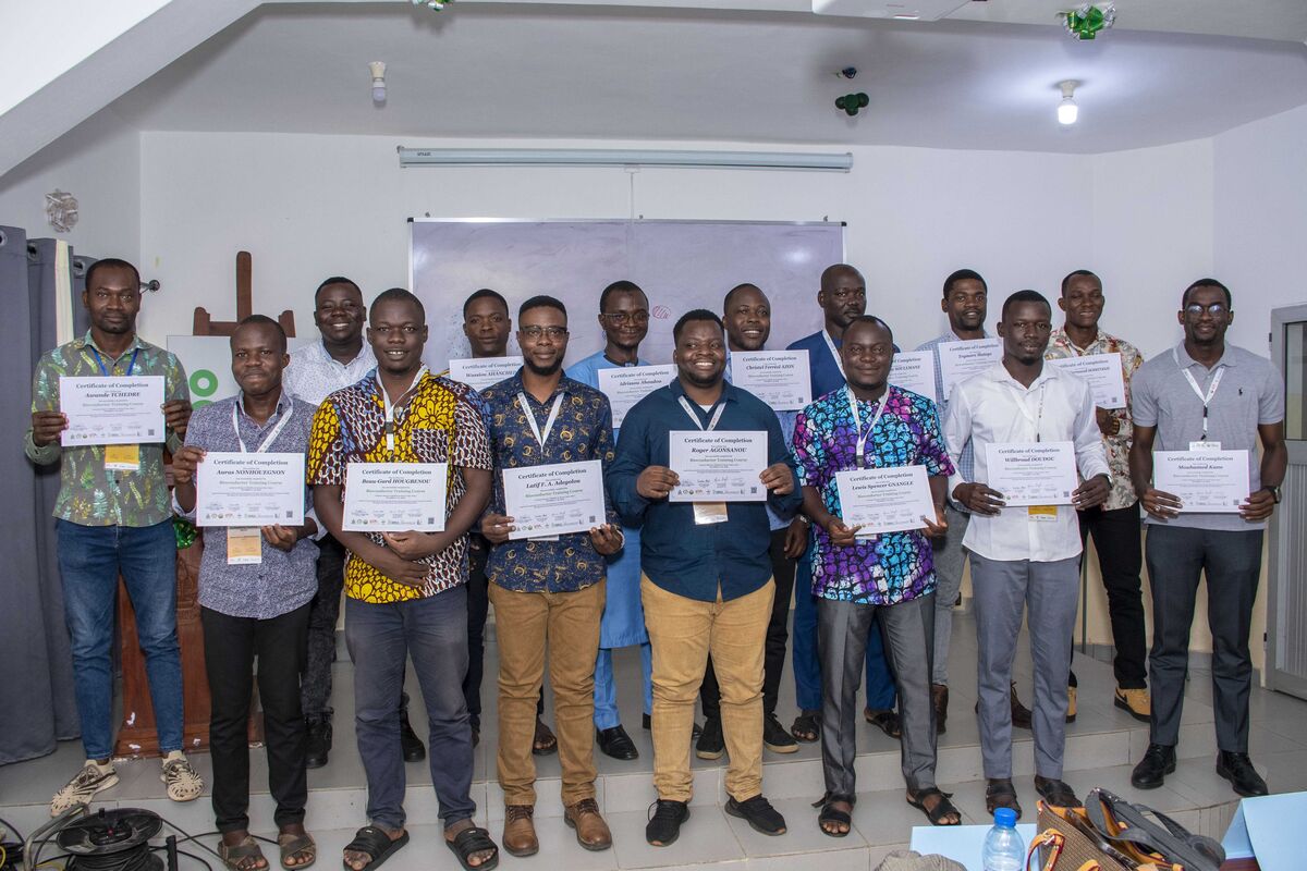 Male participants holding their certificates